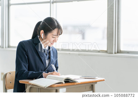 High school students and high school girls studying English using smartphone apps and earphones at school / cram school High school students and high school girls studying English using smartphone apps and earphones at school / cram school 105088772