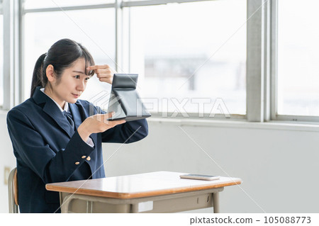 A high school girl who arranges her hair while looking at the mirror after school / during lunch break A high school girl who arranges her hair while looking at the mirror after school / during lunch break 105088773