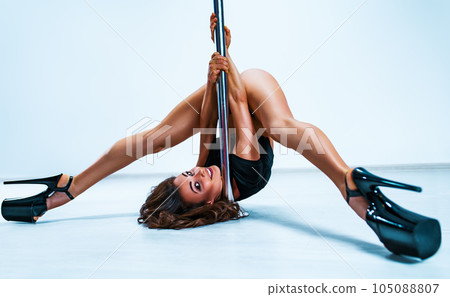 Woman pole dancing 105088807