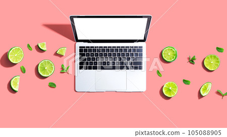 Laptop computer with fresh limes 105088905