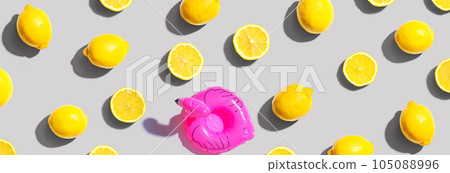 Summer concept with a pink flamingo float and lemons Summer concept with a pink flamingo float and lemons 105088996