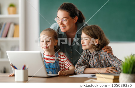 Happy kids and teacher at school Happy kids and teacher at school 105089380