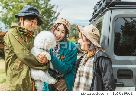 Asian men and women of campers playing with their dogs at a campsite in autumn and winter (Dog Free Site) Asian men and women of campers playing with their dogs at a campsite in autumn and winter (Dog Free Site) 105089601