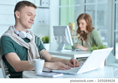 young man and woman working in office 105089926