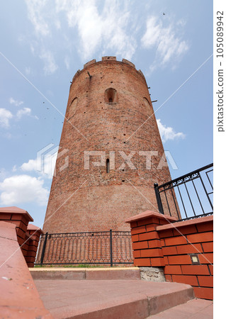 Belaya Vezha tower. From red brick. Against the background of the sky. Belaya Vezha tower. From red brick. Against the background of the sky. 105089942