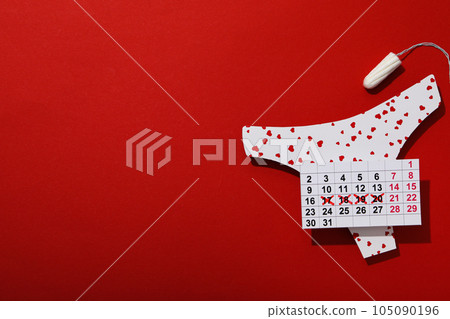 Panties, calendar and tampon for menstruation on a red background 105090196