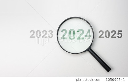 2024 inside of Magnifier glass on white background for focus current situation, positive thinking mindset concept. 2024 present in focus. 2023 2024 2025 2024 inside of Magnifier glass on white background for focus current situation, positive thinking mindset concept. 2024 present in focus. 2023 2024 2025 105090541