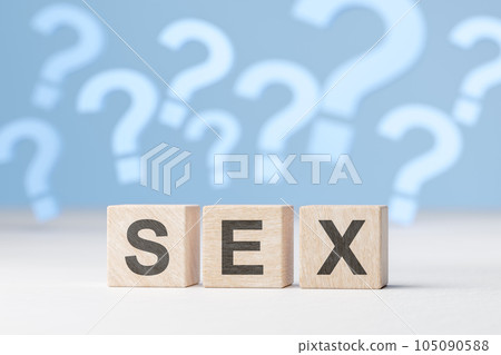 Sex question. Word sex is laid out with wooden cubes on background of many question marks. 105090588