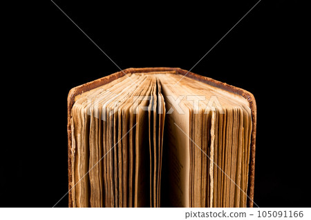 ancient book shot on black background 105091166