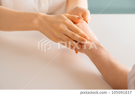 Woman doing hand massage Woman doing hand massage 105091837