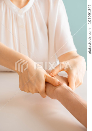 Woman doing hand massage Woman doing hand massage 105091843