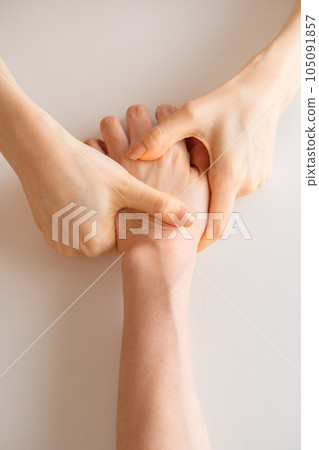 Woman doing hand massage Woman doing hand massage 105091857
