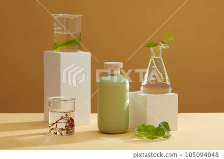 Glassware of seaweed are placed on podiums, arranged with unlabeled bottle. Seaweed helps hydrate and plump your skin for a more supple, bounce complexion 105094048