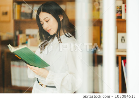 young woman in a bookstore young woman in a bookstore 105094515