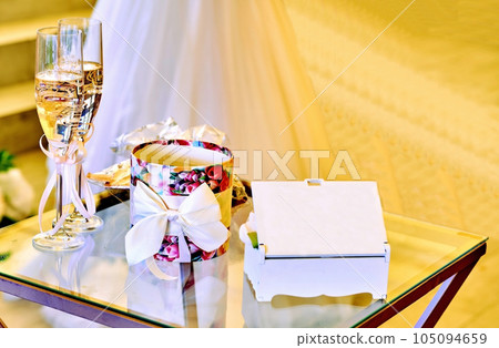 Wedding set for newlyweds. Champagne in glasses, boxes for rings and gifts 105094659