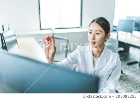 woman working in white coat woman working in white coat 105095283