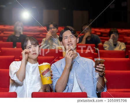 couple crying watching a sad movie 105095706