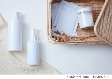 Mockup of beauty cosmetic bottle for skin care and hair care decorated with basket and towel on white background. Concept for advertising, space for design packaging Mockup of beauty cosmetic bottle for skin care and hair care decorated with basket and towel on white background. Concept for advertising, space for design packaging 105097428