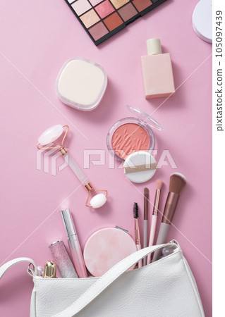 Trendy pink makeup tools on pink background: makeup brushes, eye-shadows, blush. Concept of different female accessories.  Female everyday cosmetics 105097439