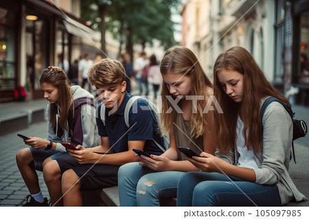 Several teens with smartphones outdoors. 105097985
