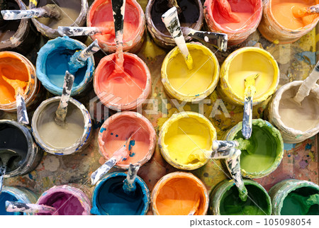 Large group of open cans of multi-colored paints Large group of open cans of multi-colored paints 105098054