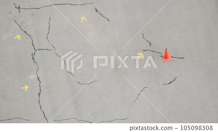 crack road texture background with arrow and cones crack road texture background with arrow and cones 105098308
