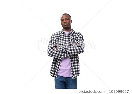 a handsome 30 year old african guy dressed in a plaid black and white shirt crossed his arms in 105099037