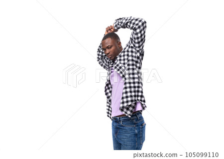 portrait of attractive dark skinned man in plaid shirt and jeans posing over isolated white 105099110