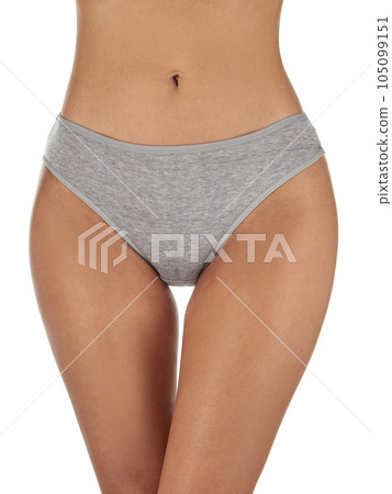 Close-up front view of a slender model girl in classic gray cotton panties for everyday wear. Front view. Isolated on white. Close-up front view of a slender model girl in classic gray cotton panties for everyday wear. Front view. Isolated on white. 105099151