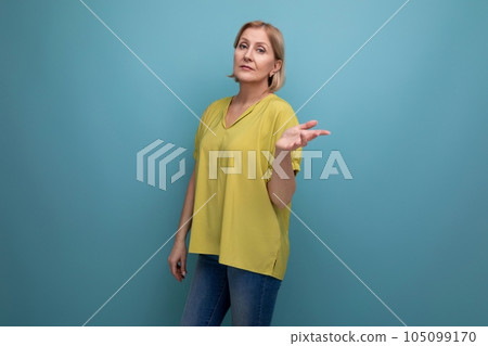 middle-aged blond woman in casual dress waving her arms middle-aged blond woman in casual dress waving her arms 105099170