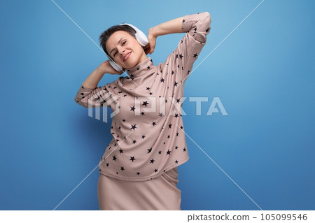 young adorable business woman with childlike features with short hair daydreaming while listening to young adorable business woman with childlike features with short hair daydreaming while listening to 105099546