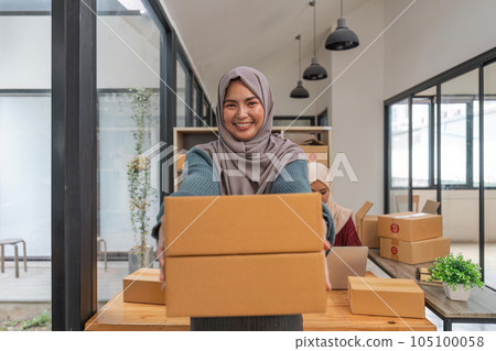 Beauty muslim woman in hijab working sell products online in the office Beauty muslim woman in hijab working sell products online in the office 105100058