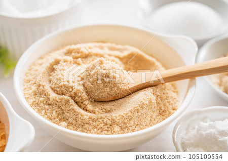 Soft brown sugar scooped with a spoon Soft brown sugar scooped with a spoon 105100554
