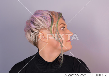 Portrait in profile of a stylish adult cute Caucasian woman with a bob hairstyle, color coloring on a studio background 105100907
