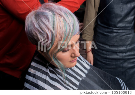 Portrait of an adult pleasant woman of Caucasian appearance with make-up and stylish fashionable bob hairstyle color creative coloring in the salon 105100913