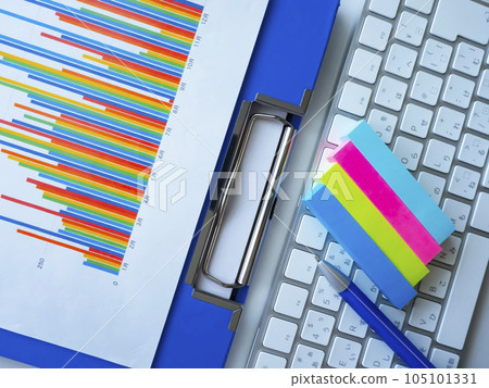 Graphs, keyboards and binders on the table 105101331