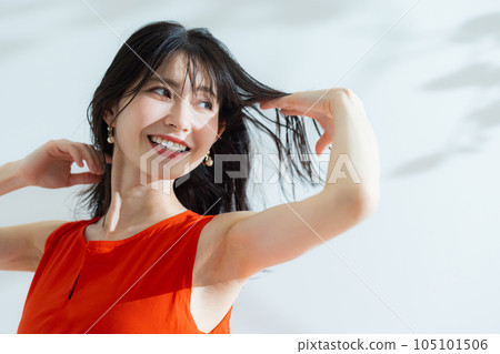 A middle-aged woman in a red dress 105101506