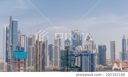 Cityscape with skyscrapers of Dubai Business Bay and water canal aerial timelapse. 105102148