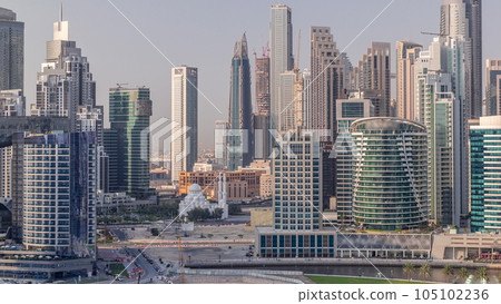 Cityscape with skyscrapers of Dubai Business Bay and water canal aerial timelapse. 105102236
