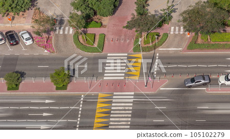 Aerial view from above to a busy road intersection in Dubai timelapse. 105102279