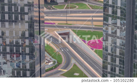 Aerial view from above to a busy road intersection in Dubai timelapse. Aerial view from above to a busy road intersection in Dubai timelapse. 105102280