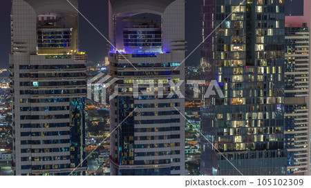 Skyline close up view of the high-rise buildings on Sheikh Zayed Road in Dubai aerial night timelapse, UAE. 105102309