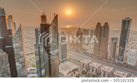 High-rise buildings on Sheikh Zayed Road in Dubai aerial timelapse during sunset, UAE. 105102329