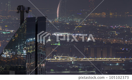 City walk houses and villas with construction site near Dubai water canal aerial night timelapse, UAE. 105102373