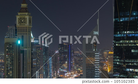 Skyline view of the high-rise buildings on Sheikh Zayed Road in Dubai aerial night timelapse, UAE. 105102385