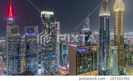Skyline view of the high-rise buildings on Sheikh Zayed Road in Dubai aerial night timelapse, UAE. Skyline view of the high-rise buildings on Sheikh Zayed Road in Dubai aerial night timelapse, UAE. 105102402