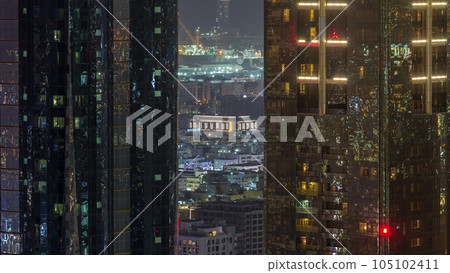 Aerial view of apartment houses and villas in Dubai city near downtown night timelapse. Aerial view of apartment houses and villas in Dubai city near downtown night timelapse. 105102411