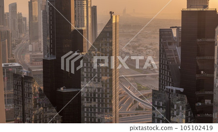 High-rise buildings on Sheikh Zayed Road in Dubai aerial timelapse during sunset, UAE. 105102419