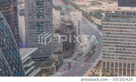 Aerial view of traffic on Al Saada street in financial district day to night timelapse in Dubai, UAE. 105102420
