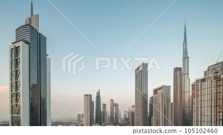 Aerial view of Dubai Downtown skyline with many towers day to night timelapse. 105102460